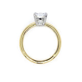 side view of an 18K gold ring with a cushion diamond on a white background
