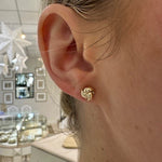 Woman wearing 14K Yellow Gold Love Knot Earrings