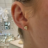 Woman wearing 14K Yellow Gold Love Knot Earrings