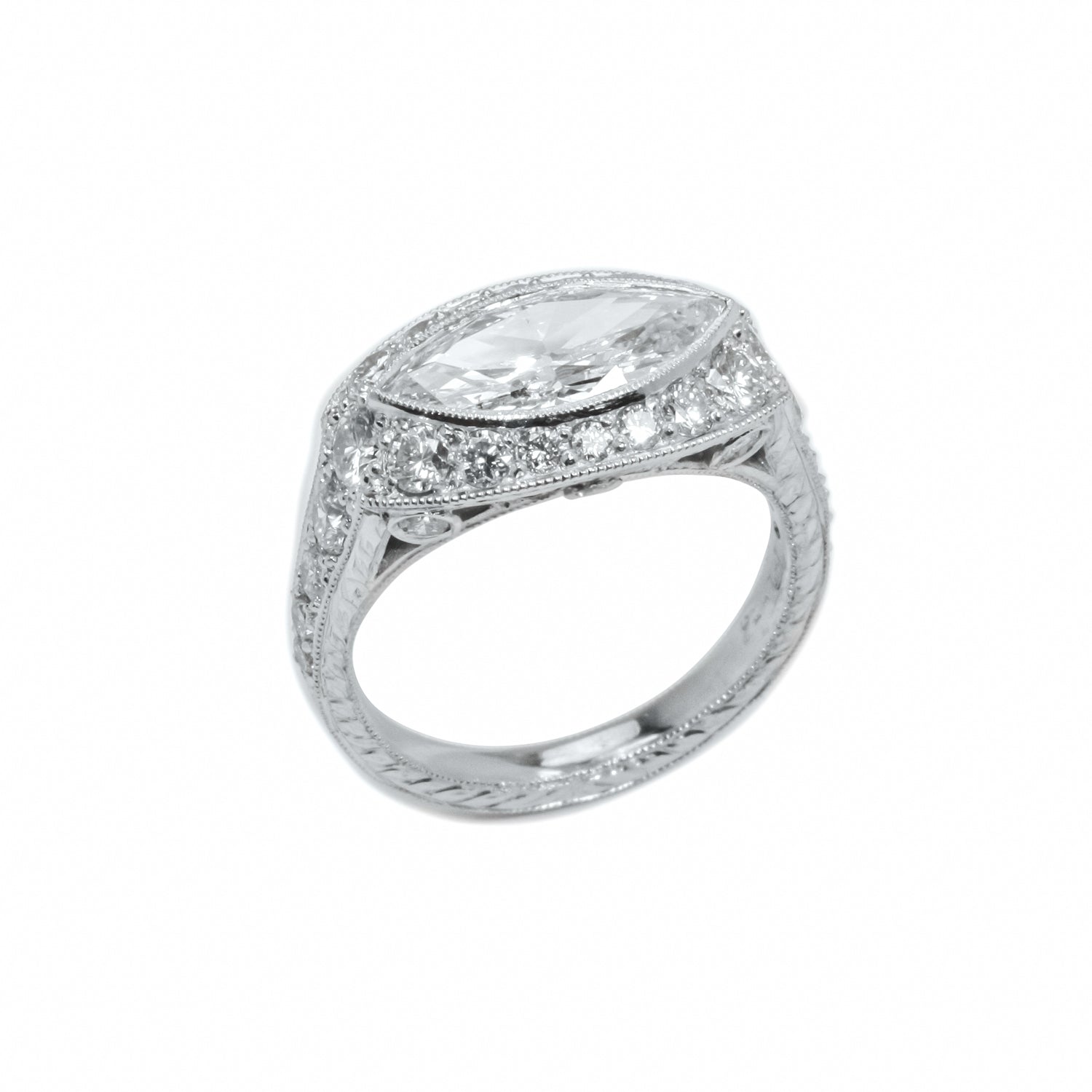 A platinum marquise diamond ring with a halo of smaller diamonds around the top.