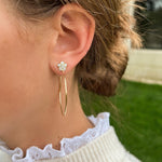 18K yellow gold and diamond hoops designed by Laura Pearce on model