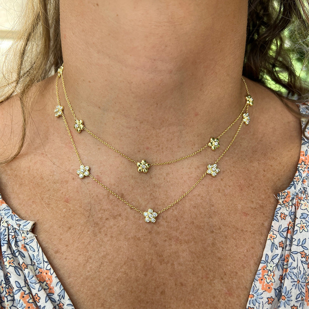 woman wearing two Merrimon 5 station 18K gold necklaces