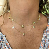 woman wearing two Merrimon 5 station 18K gold necklaces