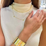 Woman wearing a gold bracelet and necklace 