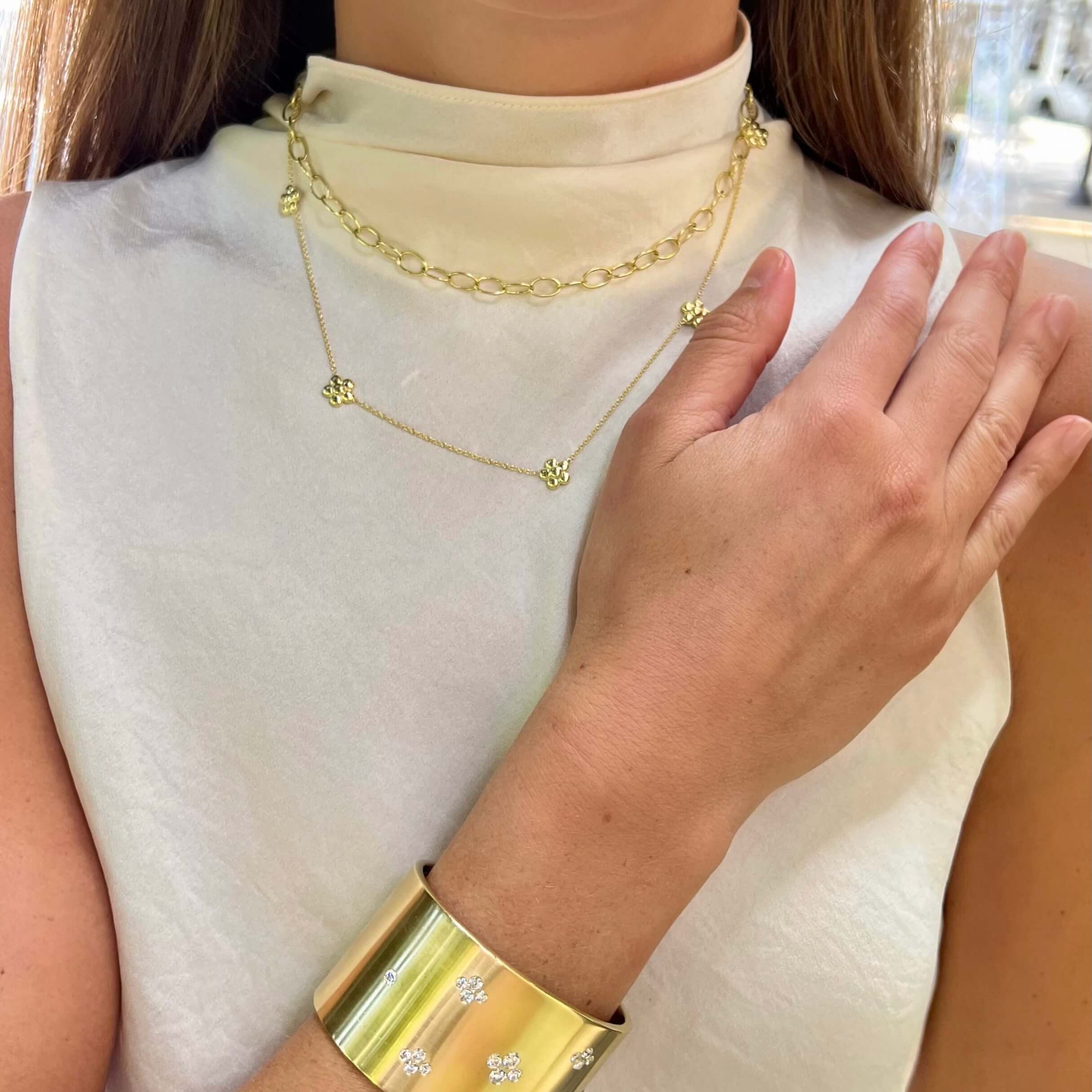 Woman wearing a gold bracelet and necklace 
