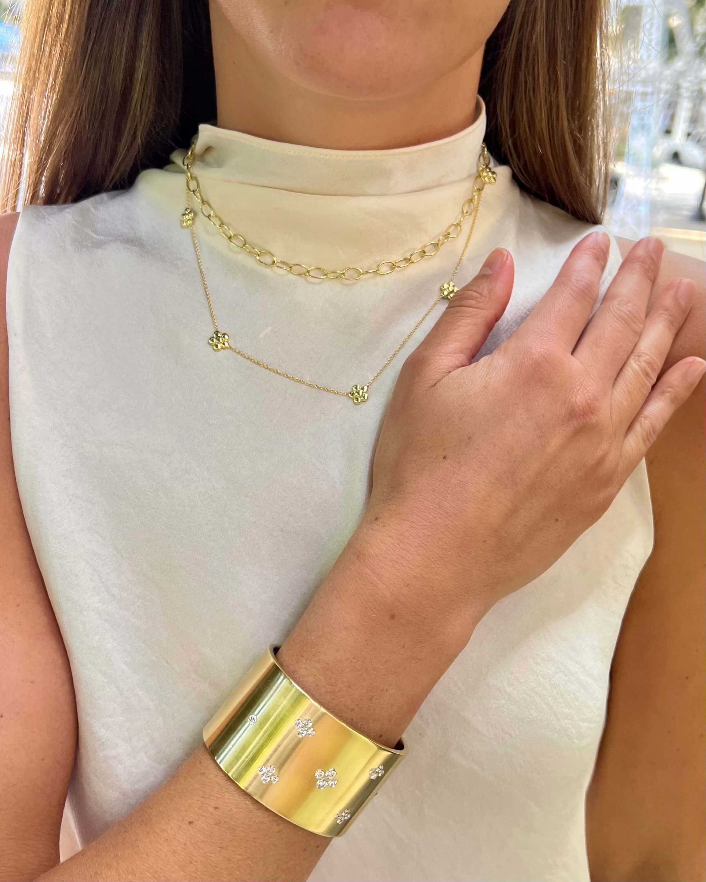 Woman wearing a gold bracelet and necklace 