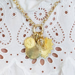 Multiple 18K yellow gold charm pendants on a necklace 
