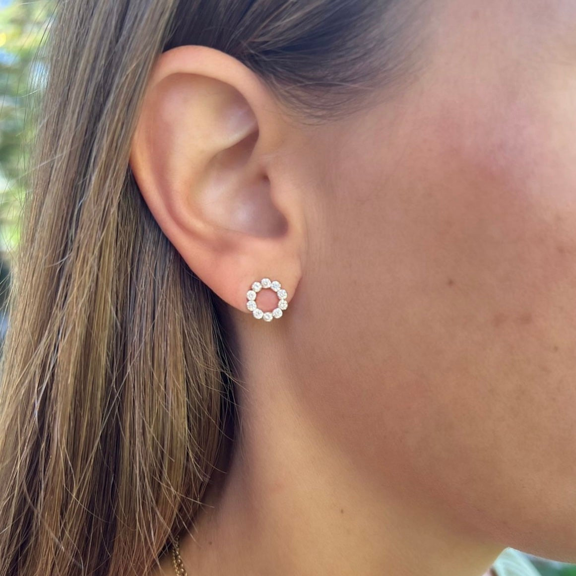 Woman wearing 18K Yellow Gold Open Circle Diamond Studs