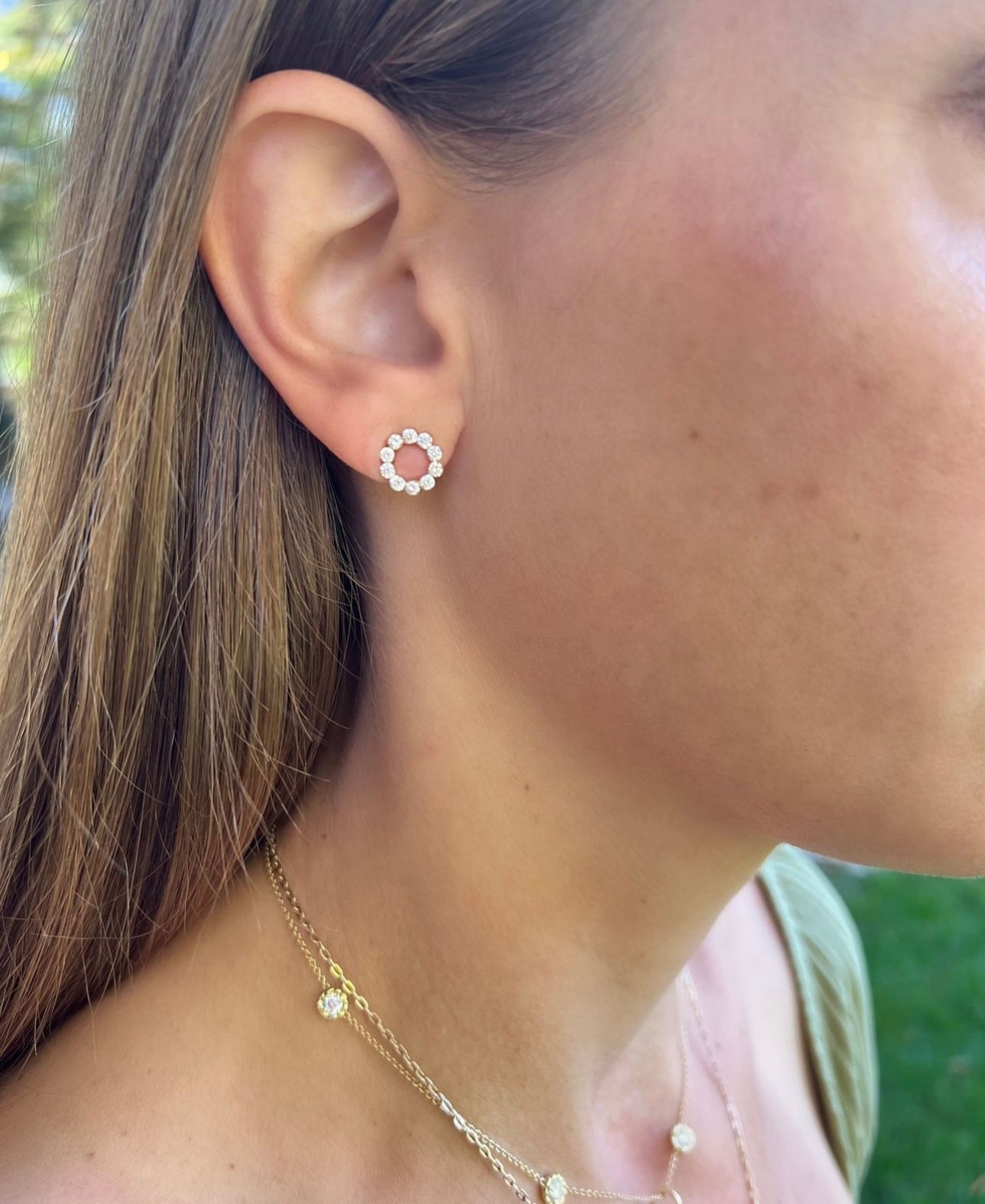 Woman wearing 18K Yellow Gold Open Circle Diamond Studs