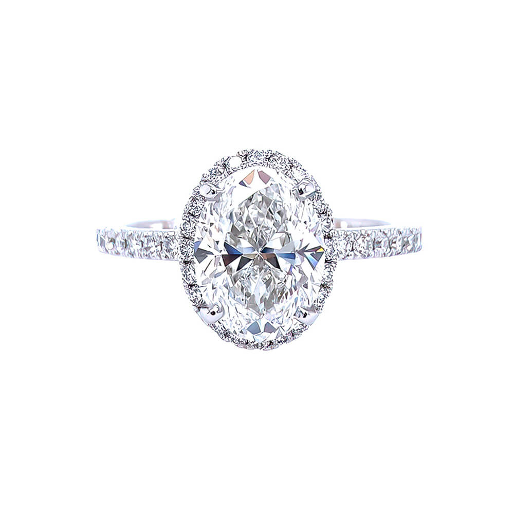 An oval-cut diamond engagement ring with a halo setting and a pavé band, shown on a solid white background.