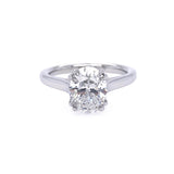 A classic solitaire engagement ring featuring an oval brilliant-cut diamond set in a polished platinum band, shown against a plain white background.