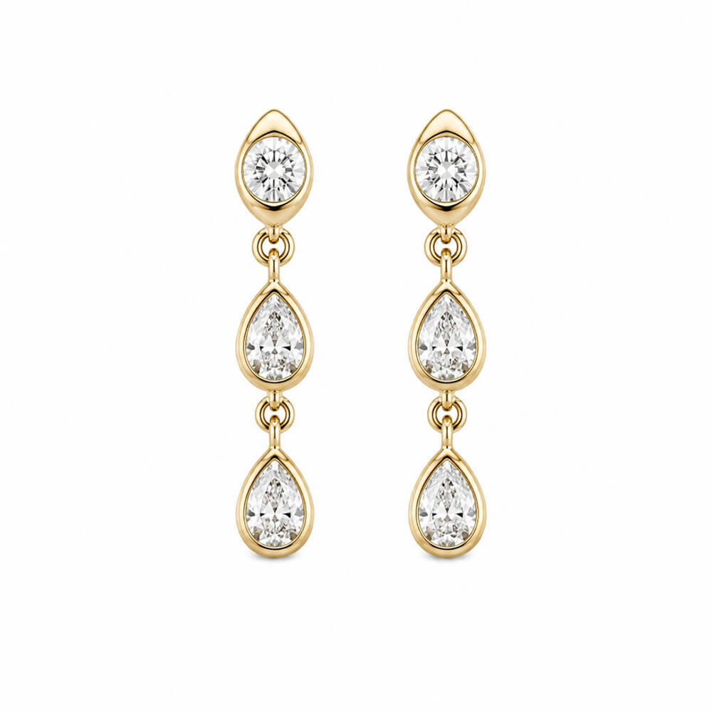 A pair of 14K gold dangle earrings with three bezel set diamonds in each earring, on a plain white background.