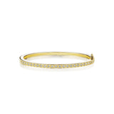 Gold bracelet with small box-set diamonds on a white background