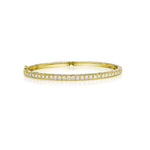 An 18K yellow gold bangle bracelet with Pave diamonds set around its circumference.