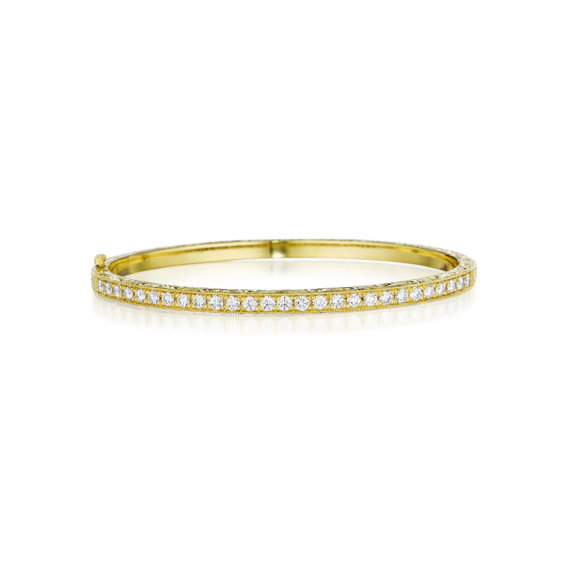 An 18K yellow gold bangle bracelet with Pave diamonds set around its circumference.
