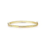 An 18K yellow gold bangle bracelet with triple box set of diamonds.