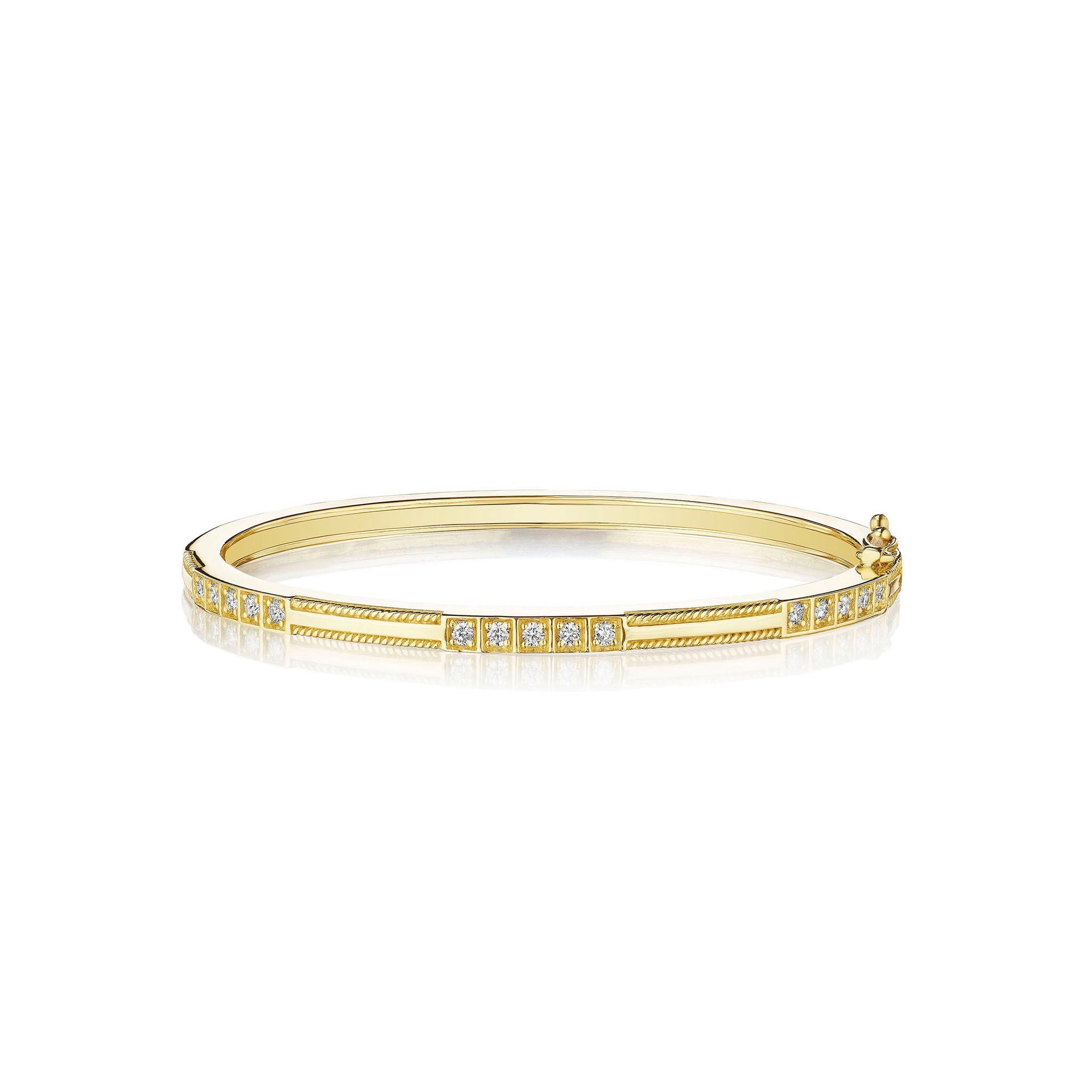 An 18K yellow gold bangle bracelet with triple box set of diamonds.