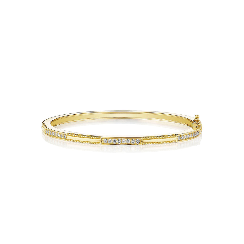 An 18K yellow gold bracelet with triple diamond bars station design.