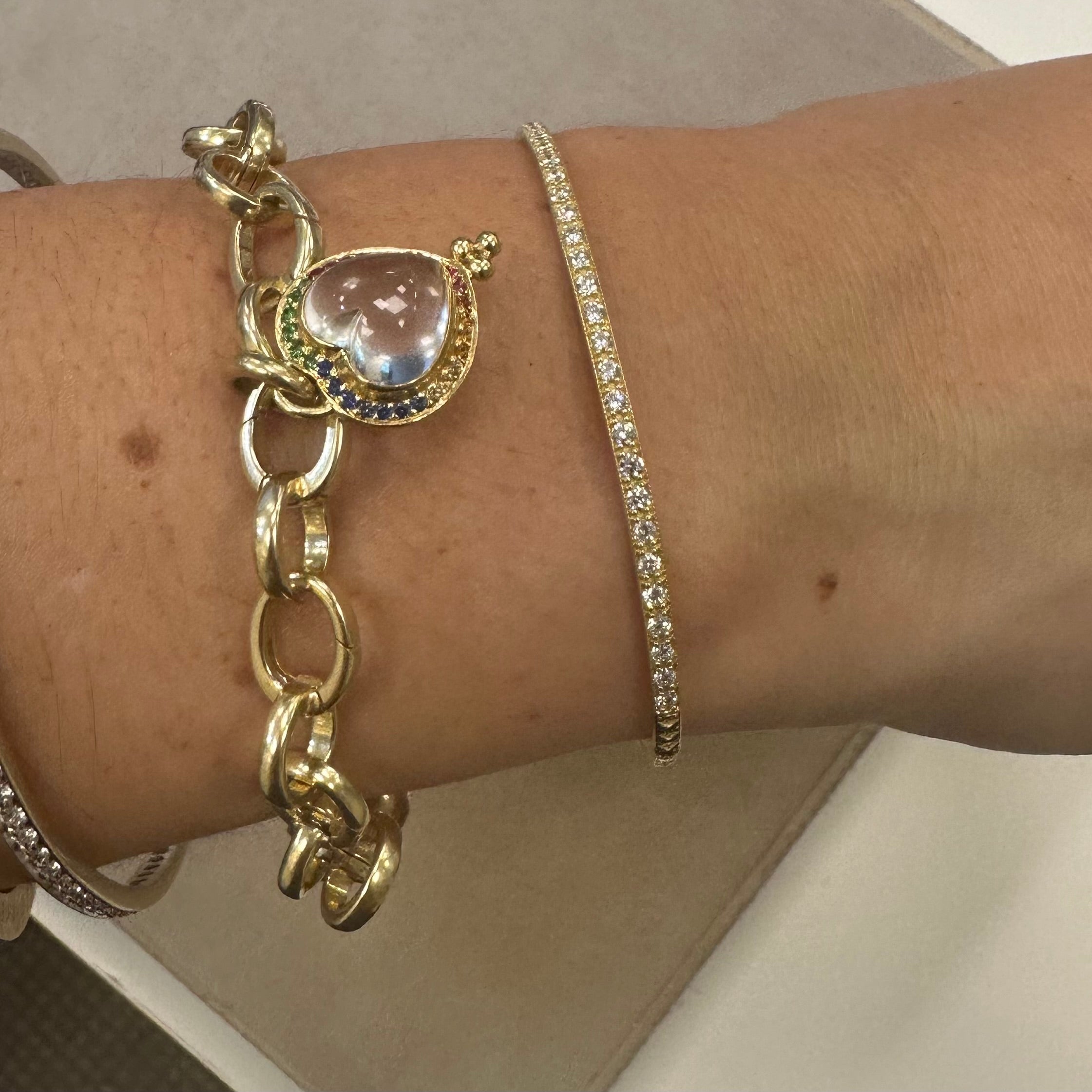 Woman wearing gold bracelets.