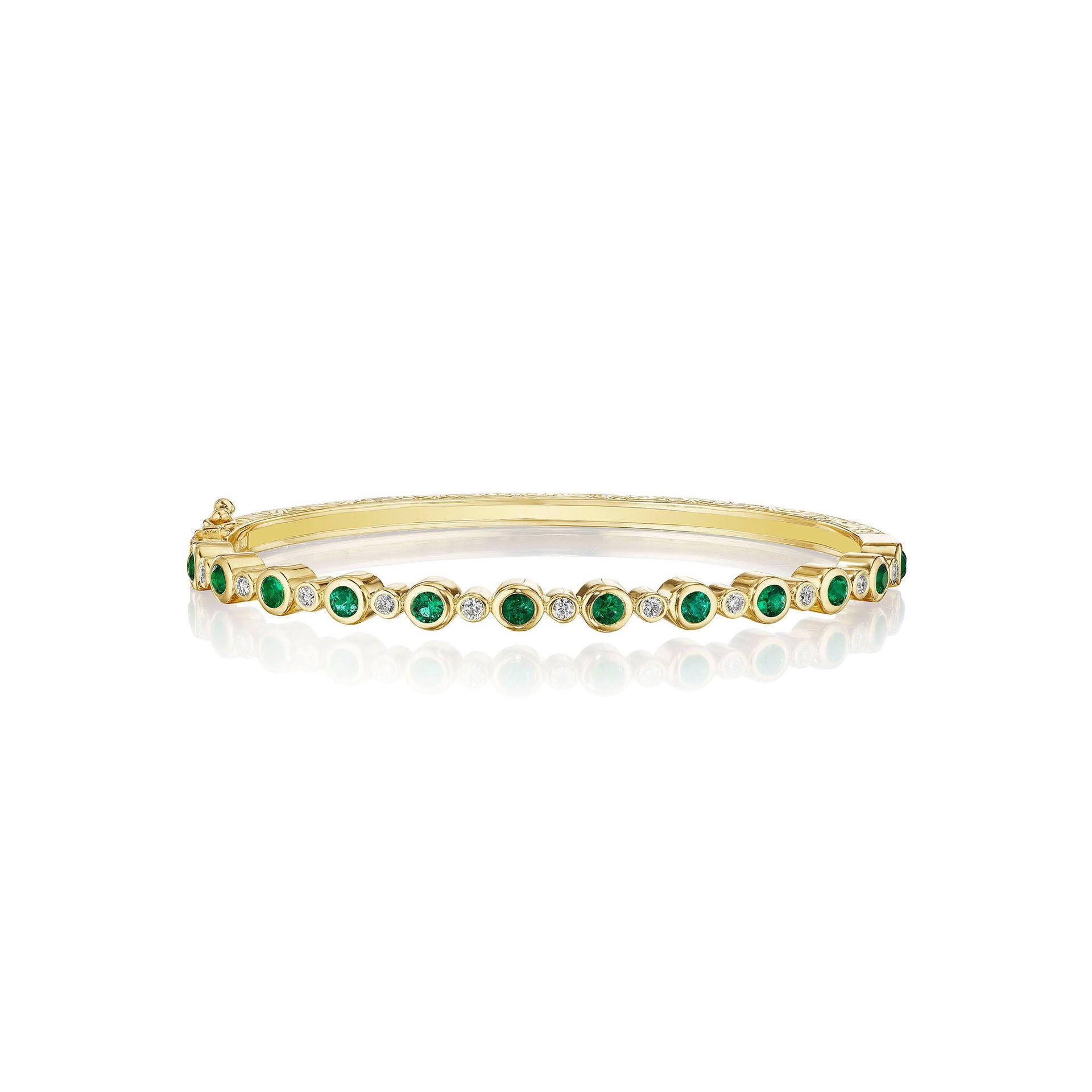 A yellow gold bangle bracelet with green emerald stones and diamond accents.