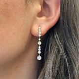 Woman wearing Penny Preville 18K white gold dangling earring