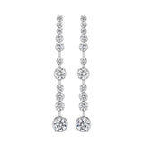 Pair of 18K white gold and diamond earrings on a white background