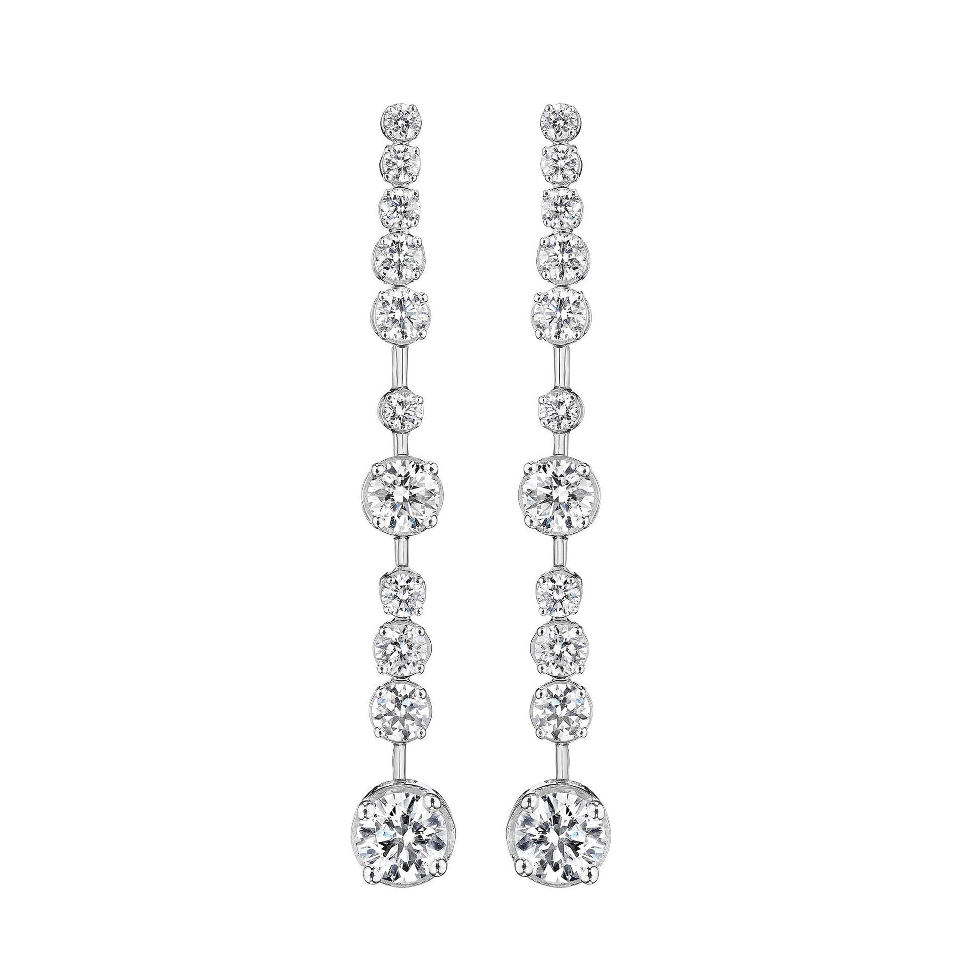 Pair of 18K white gold and diamond earrings on a white background