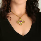 19K Gold necklace with a cross pendant featuring purple amethysts and green peridots designed by Elizabeth Locke
