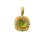 19K Gold pendant with a large Peridot gemstone on a white background