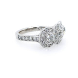 A platinum diamond ring with a three-stone cluster setting and pavé band, photographed on a clean white background.