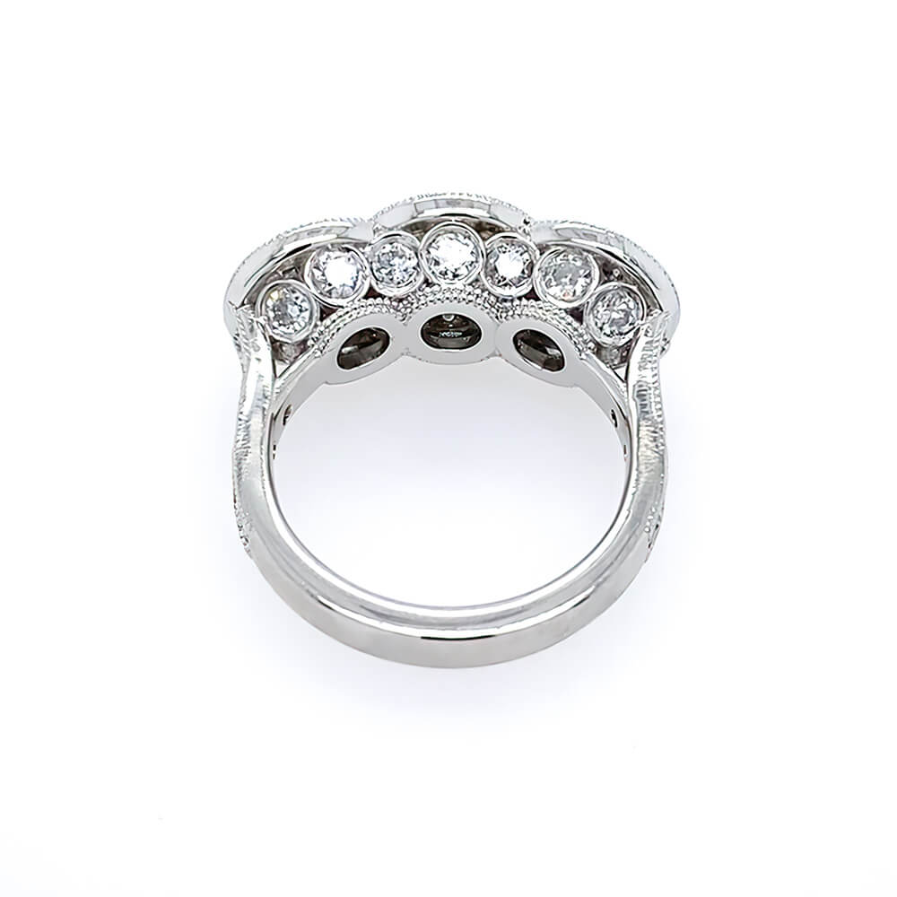 A platimun vintage-style ring featuring three bullseye diamonds