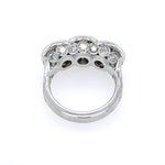 A platimun vintage-style ring featuring three bullseye diamonds