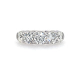 A platinum ring with five round-cut diamonds set in a row.