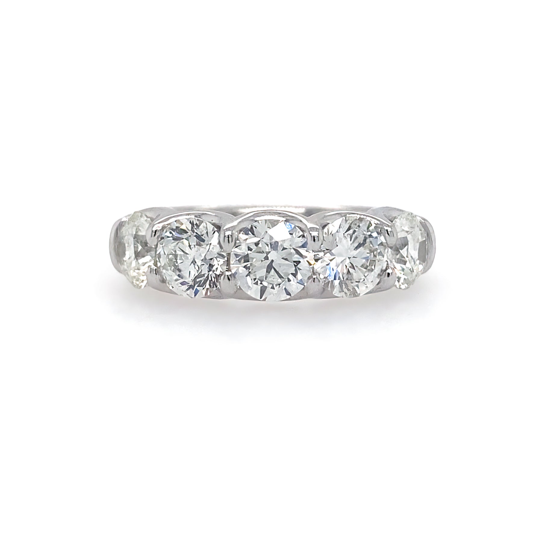A platinum ring with five round-cut diamonds set in a row.