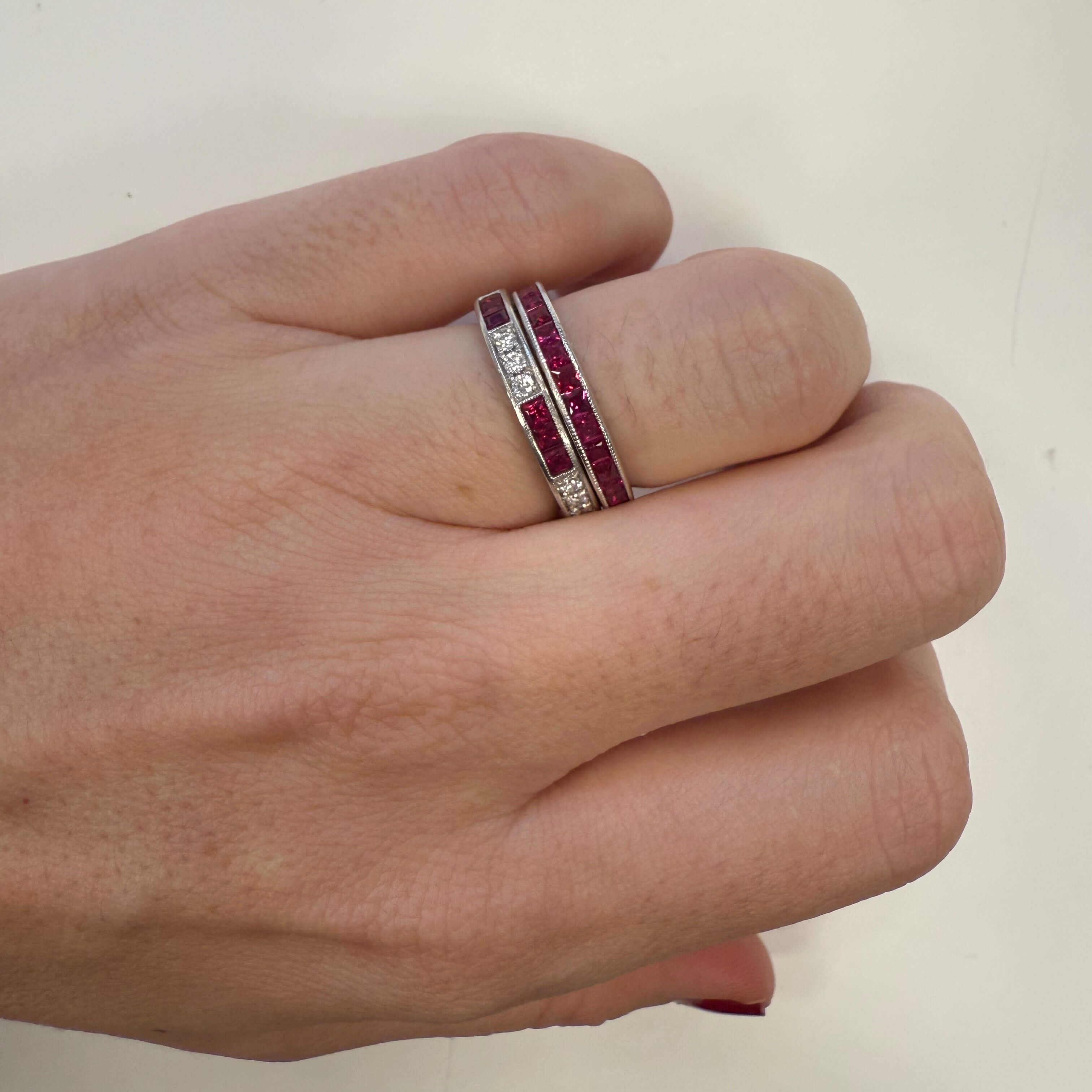 woman wearing platinum Ruby and Diamond rings