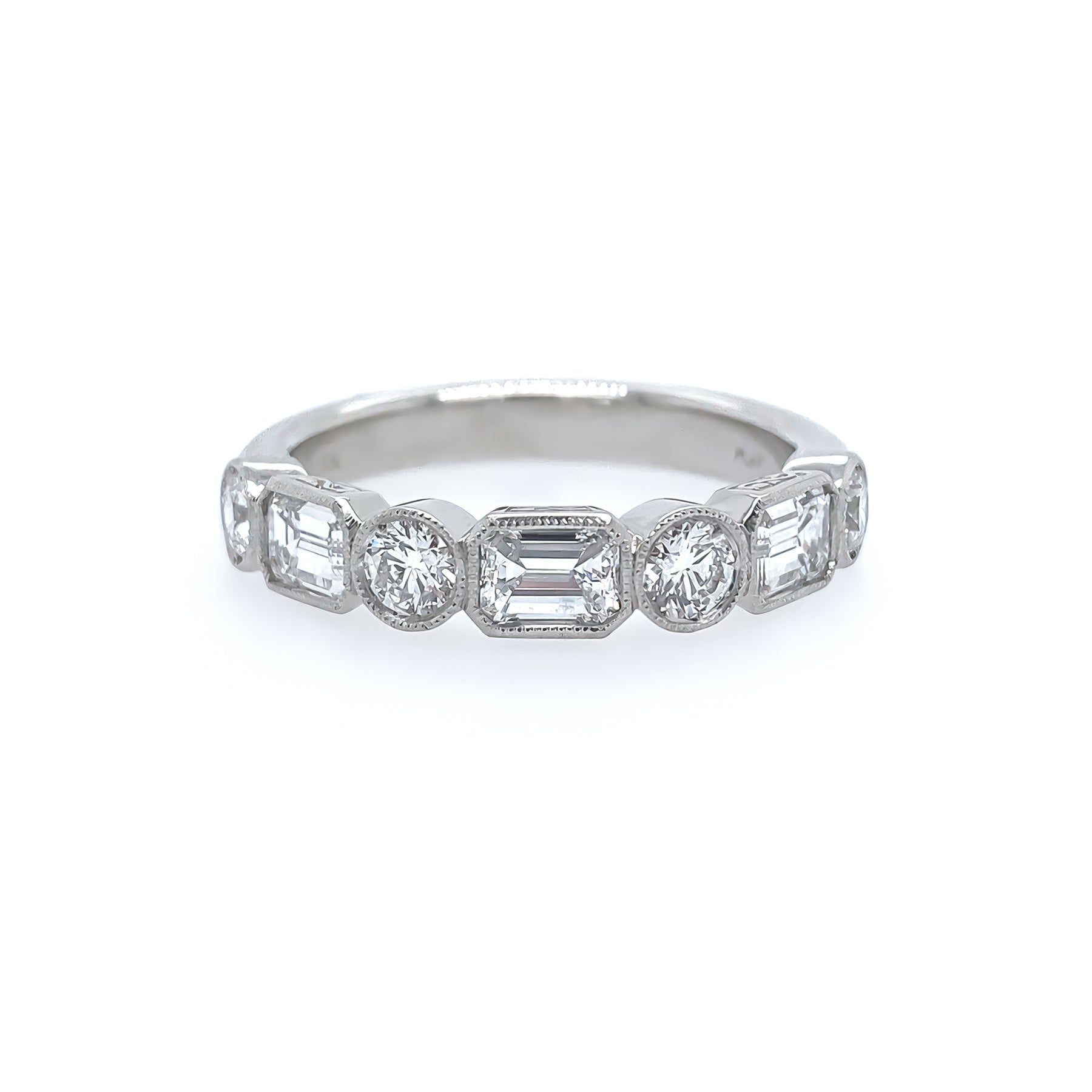 Platinum Diamond ring with emerald-cut and round diamonds on a white background