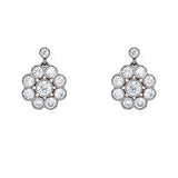 A pair of platinum cluster earrings featuring multiple round-cut clear diamonds arranged in a floral or sunburst pattern, shown on a plain white background.
