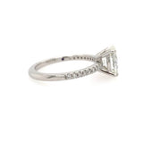 A platinum diamond ring featuring a large oval clear diamond in a prong setting, with a pavé band of small round diamonds on the band.