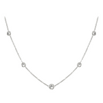 Delicate platinum necklace with small round pendants on a white background