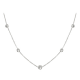Delicate platinum necklace with small round pendants on a white background