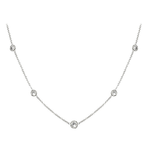 Delicate platinum necklace with small round pendants on a white background