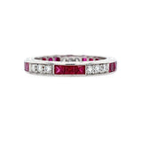 Platinum ring with rubies and diamonds on a white background