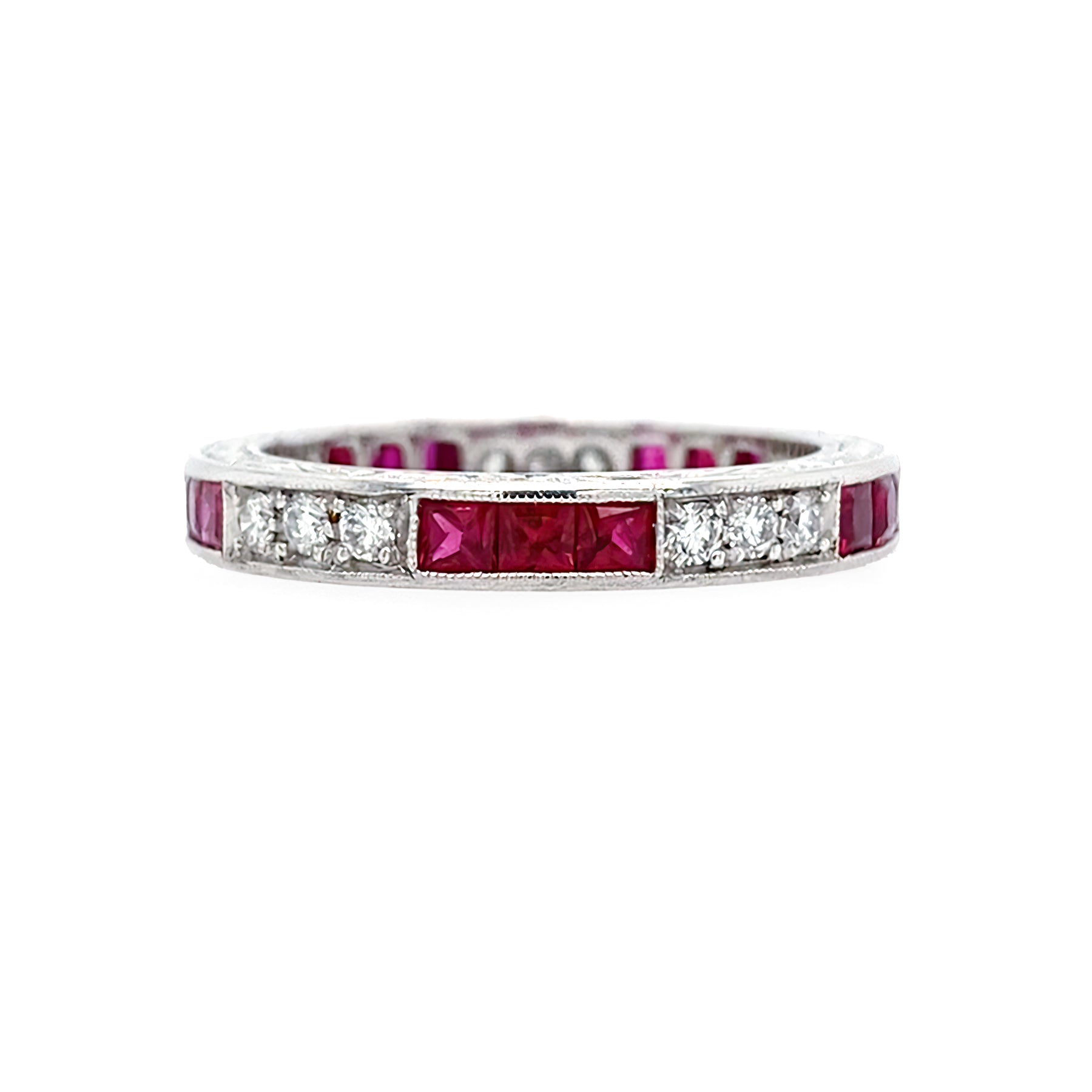 Platinum ring with rubies and diamonds on a white background