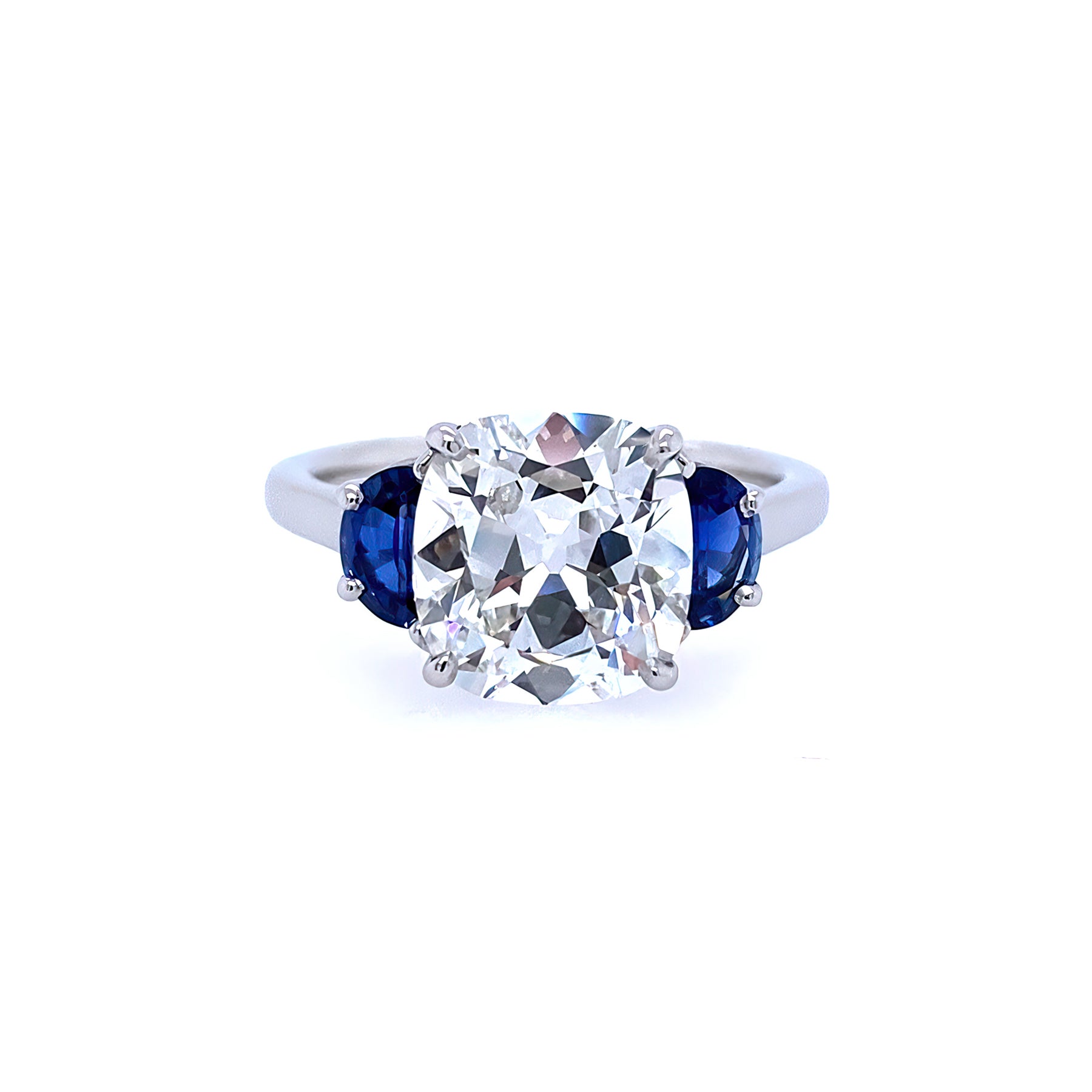 A platinum cushion cut diamond ring with half moon sapphire sides