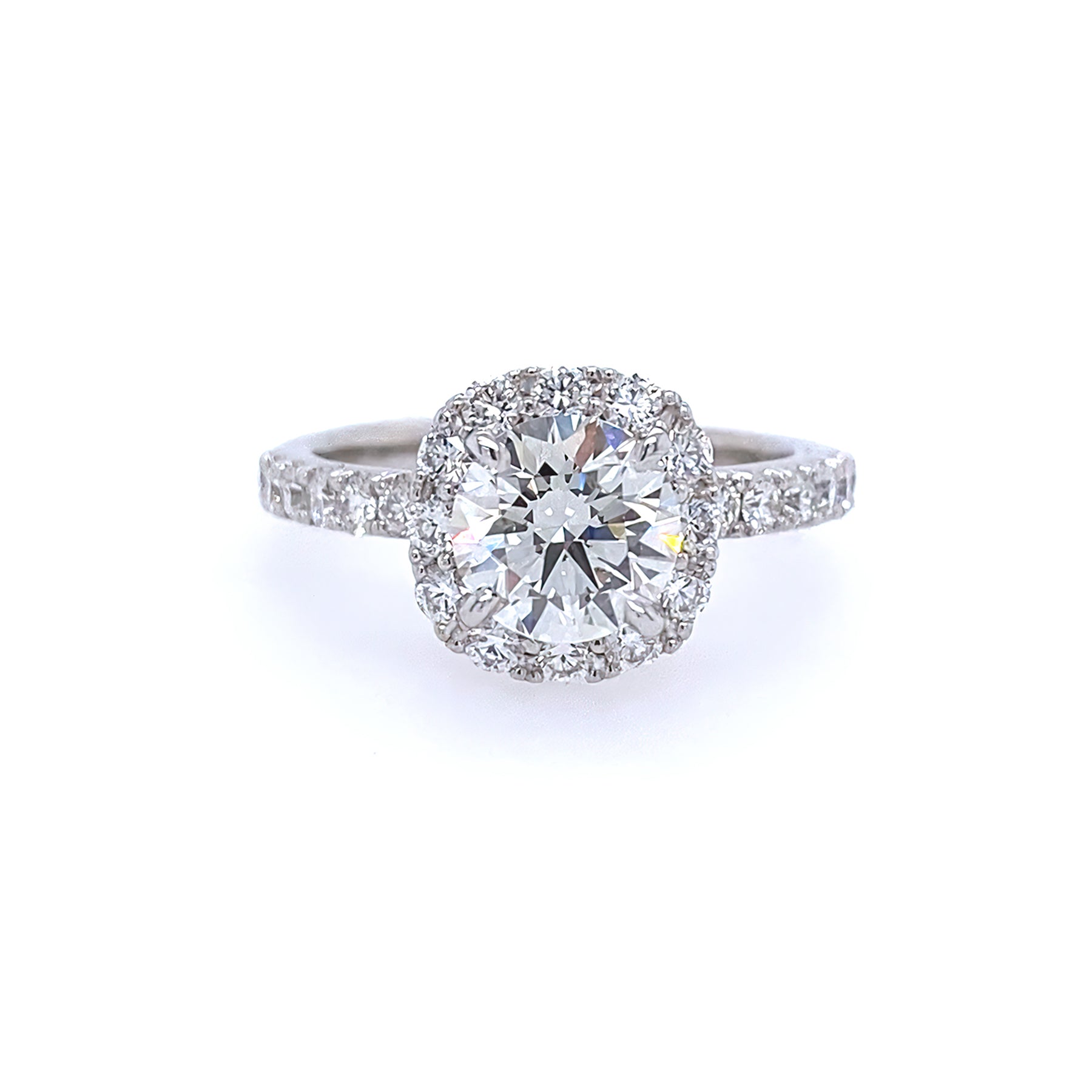 A platinum band ring with a central diamond and smaller diamonds set around it.