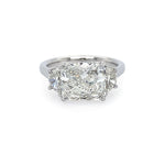 A platinum ring with a radiant cut design, featuring a central diamond surrounded by half moon shaped diamonds