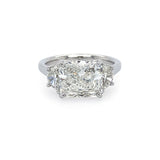 A platinum ring with a radiant cut design, featuring a central diamond surrounded by half moon shaped diamonds