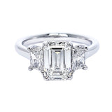 Custom Platinum engagement ring with emerald-cut center diamond on a white background
