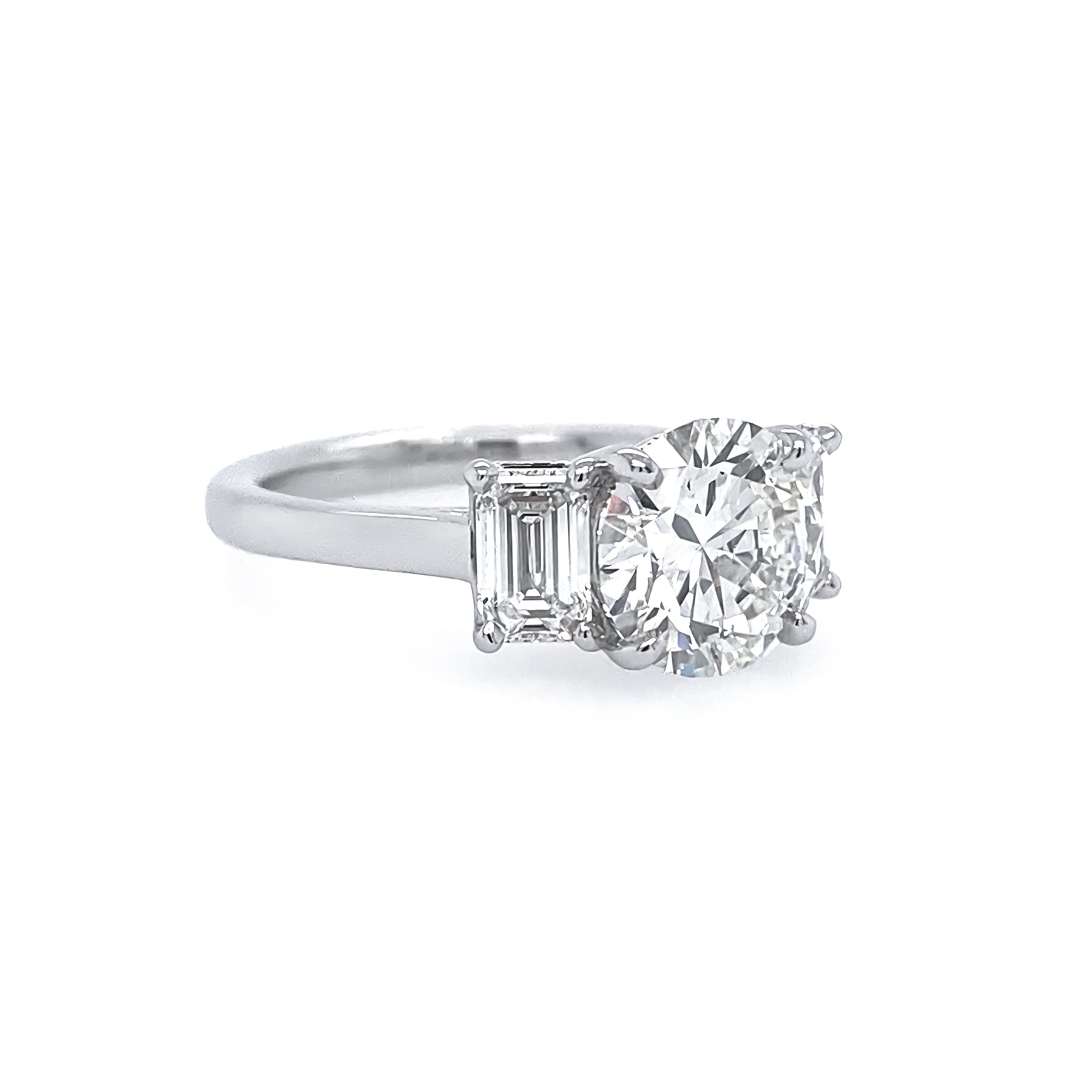 Platinum Round Diamond Ring with Emerald Cut Side Stones