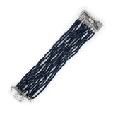Sapphire beaded bracelet with Platinum clasp laid out on a white background